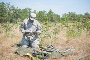 Spc. Homer Byers, a signal system support specialist, for the 558th Signal Company, from Maineville, Ohio, reads instructions for his equipment during the 2014 Quartermaster Liquid Logistics Exercise (QLLEX), operationally controlled by the 633rd Quartermaster Battalion, in Ft. Bragg, June 8, 2014. (U.S. Army photo by Spc. Miguel Alvarez/ Released)