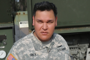 Sgt. Pablo Rey, water treatment specialist with the 431st Quartermaster Detachment, strikes a pose following his rendition of Blue Christmas reminiscent of those done on stage by Elvis Presley during the 2014 Quartermaster Liquid Logistics Exercise (QLLEX), operationally controlled by the 633rd Quartermaster Battalion here, at Fort Bragg, N.C. June 9, 2014. Rey, a native of Orlando, Fla., works as a professional Presley tribute artist outside of his Army duties and has performed all over the world singing for thousands of people. (U.S. Army photo by Pfc. Justin Snyder/Released)
