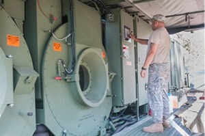 Staff Sgt. Rosario Luis, a shower/laundry and clothing repair specialist with the 430th Quartermaster Company, based out of Fort Buchanan, Puerto Rico, checks the control panel on the Laundry Advanced Systems (LADS) at the 2014 Quartermaster Liquid Logistics Exercise (QLLEX), operationally controlled by the 633rd Quartermaster Battalion here, in Fort Bragg, N.C., June 9, 2014. (U.S. Army photo by Sgt. Dalton Smith/Released)