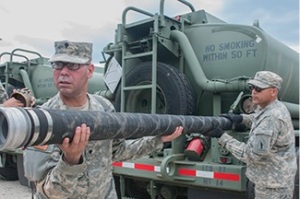 Motor transportation operators, with the 773rd Transportation Company, based out of Queens, N.Y., inspect their fuel lines before their Q-Day (Quality Day) inspection for the 2014 Quartermaster Liquid Logistics Exercise (QLLEX), operationally controlled by the 633rd Quartermaster Battalion here, in Fort Bragg, N.C., June 8, 2014. (U.S. Army photo by Sgt. Dalton Smith/Released)